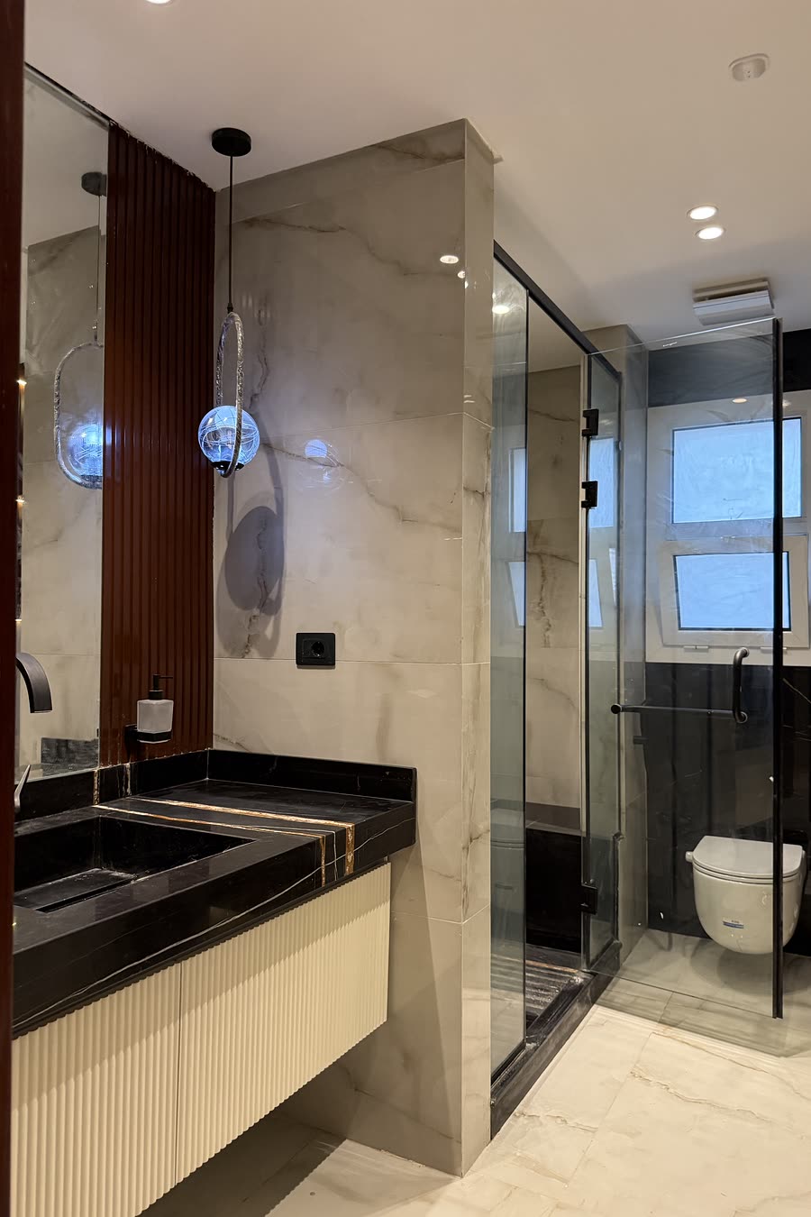 Hyde Park bathroom with black marble vanity and glass shower