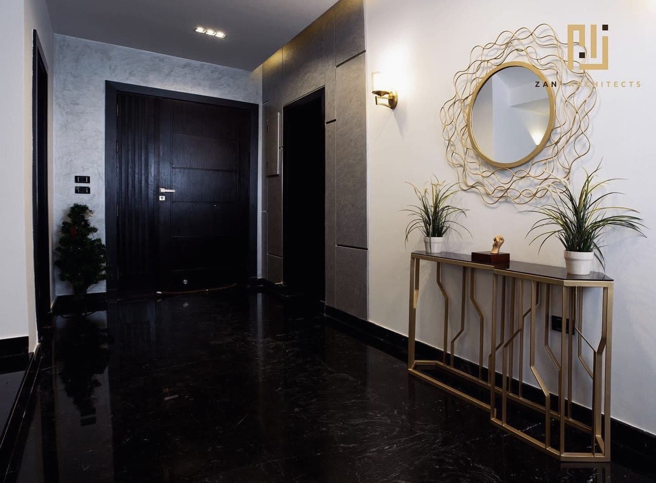 Palm Hills entrance hall with dark marble floor and gold mirror
